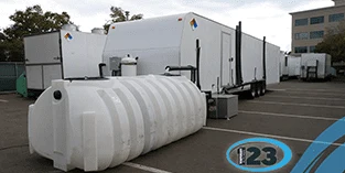 White water-storage tank beside temporary units